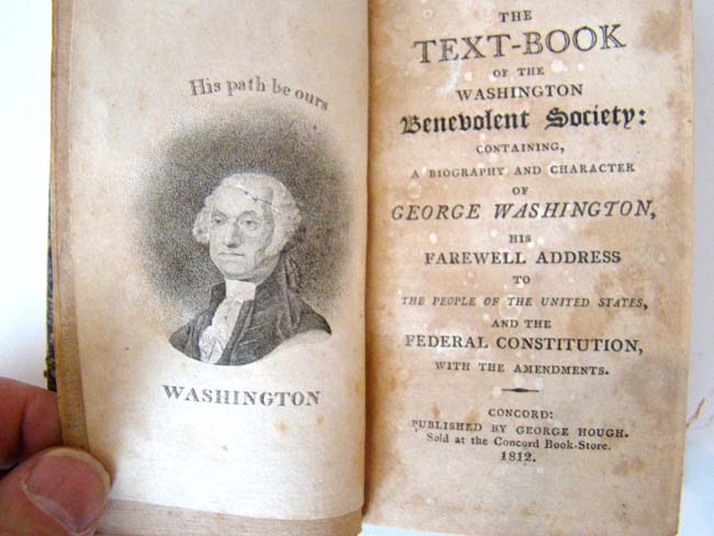 A RARE book titled "The Text-Book of the Washington Benevolent Society" published by George Hough in 1812.